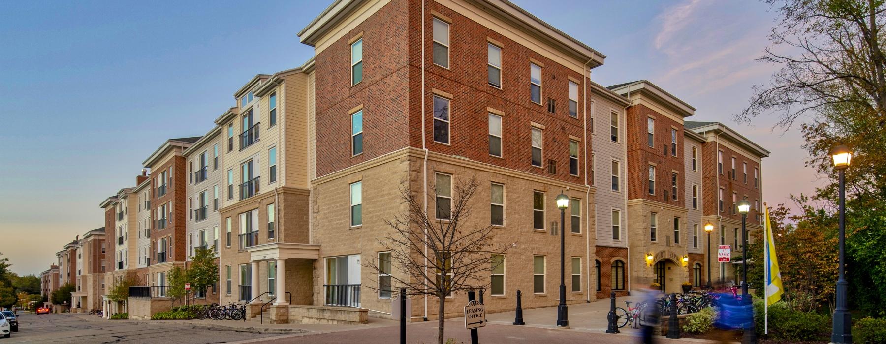 a brick building with a tree in front of it