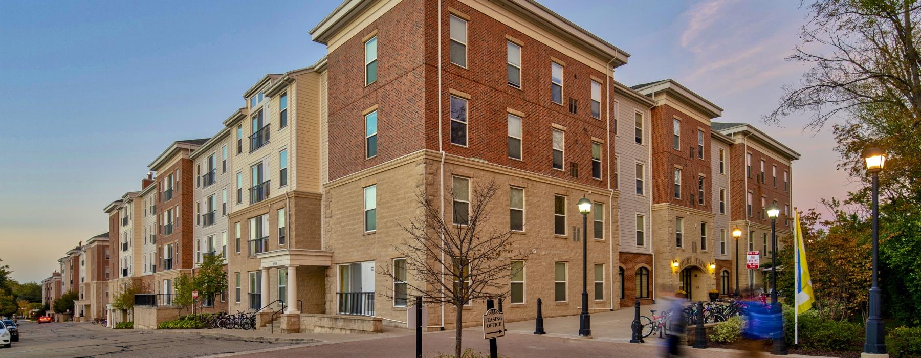 a brick building with a tree in front of it